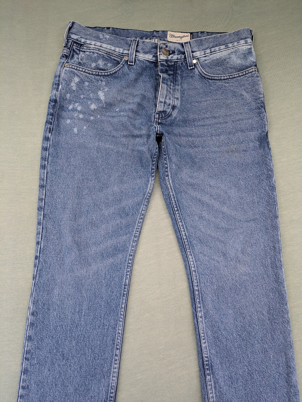 Wrangler blue straight jeans with button fly and classic 5-pocket design.