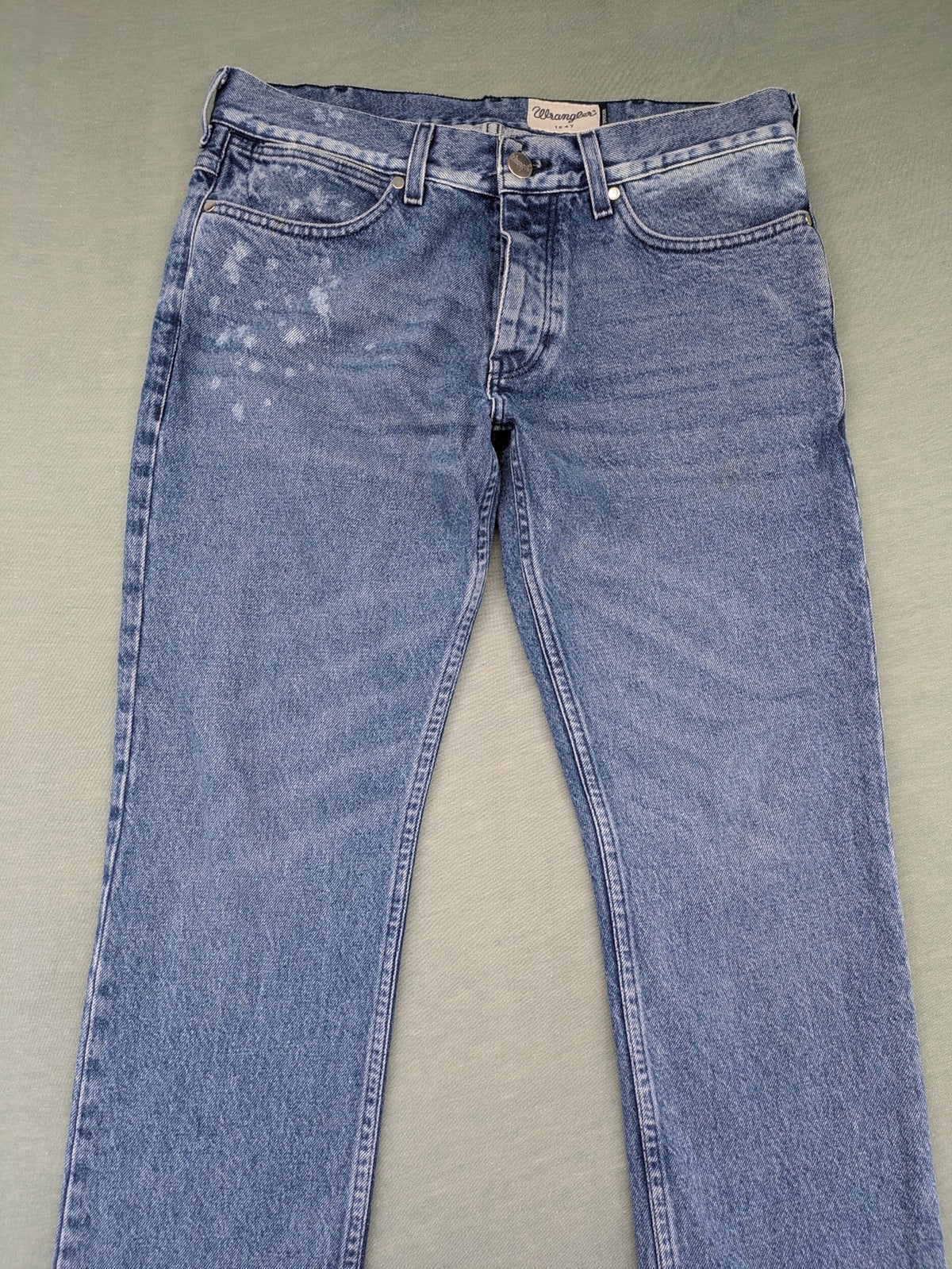 Wrangler blue straight jeans with button fly and classic 5-pocket design.