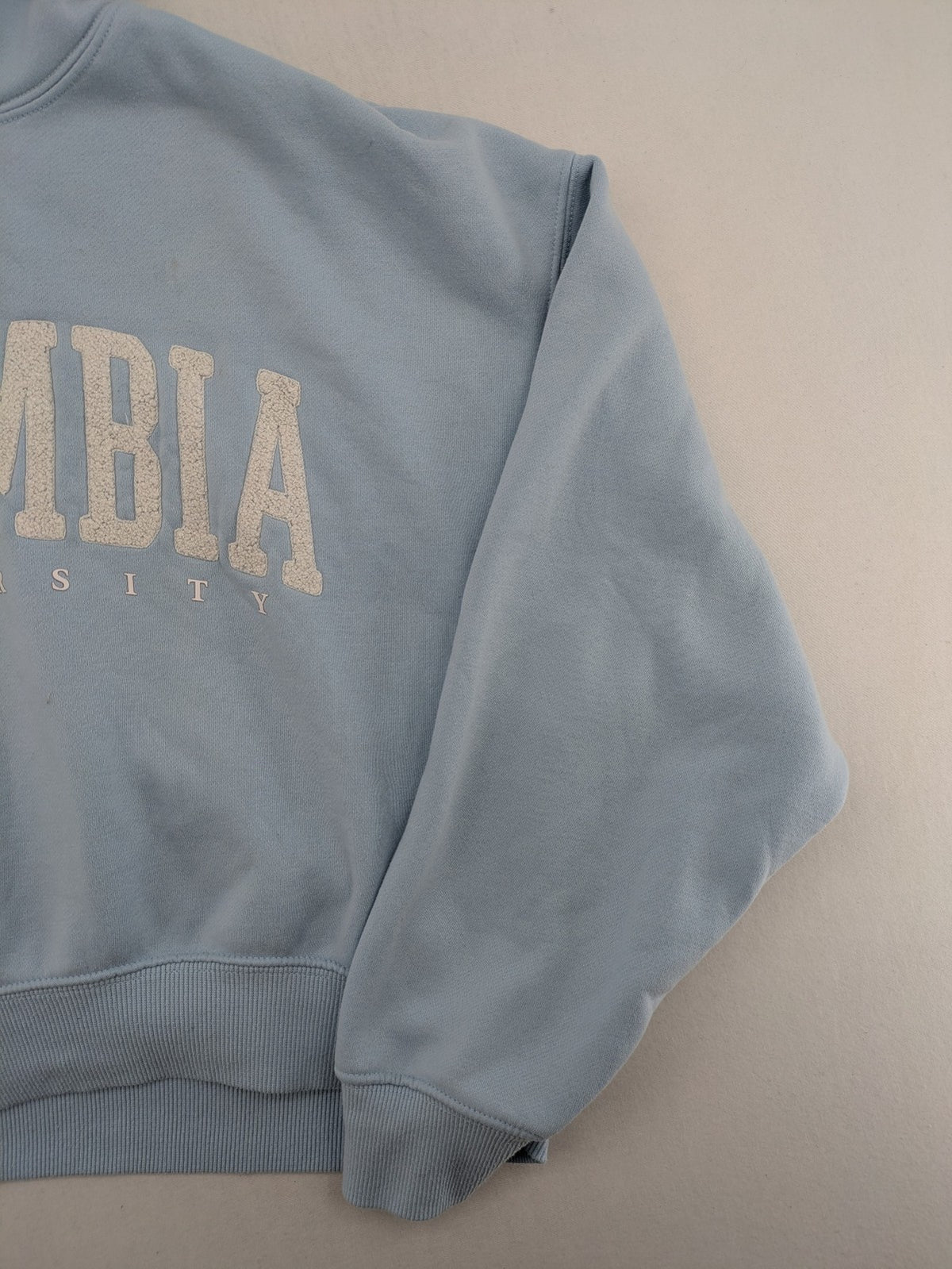Columbia University blue hoodie with large "Columbia University" text on chest.