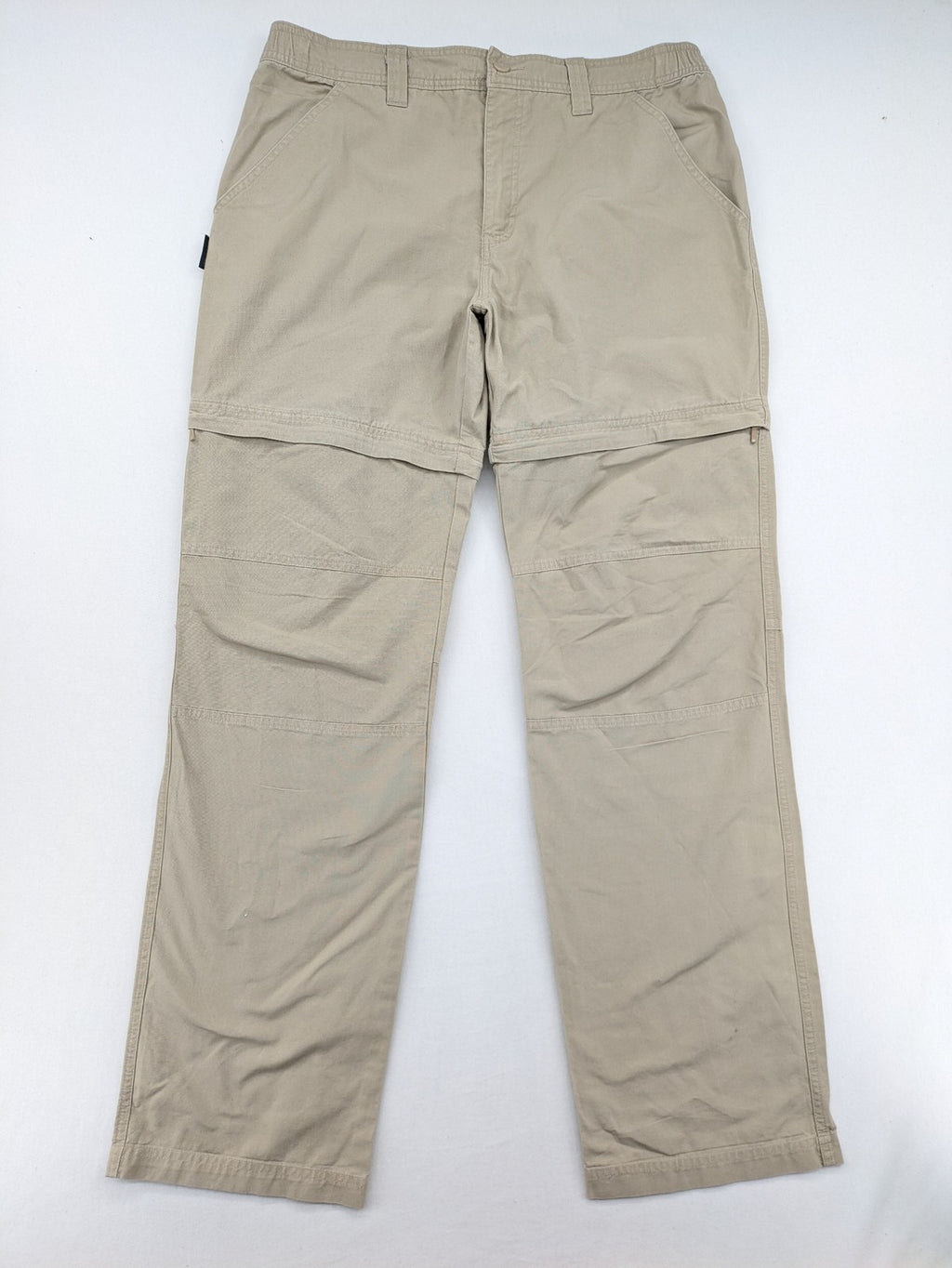 Quechua khaki convertible hiking pants with zip-off legs and durable cotton fabric.