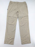 Quechua khaki convertible hiking pants with zip-off legs and durable cotton fabric.