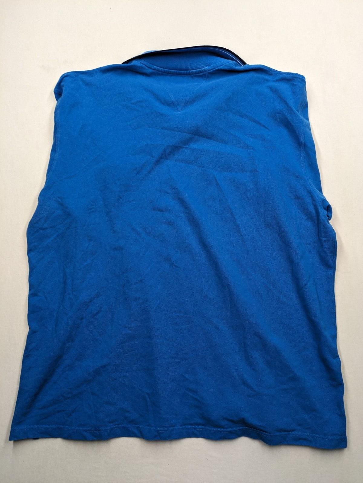 Tommy Hilfiger blue polo shirt with white stripes and embroidered logo on chest.