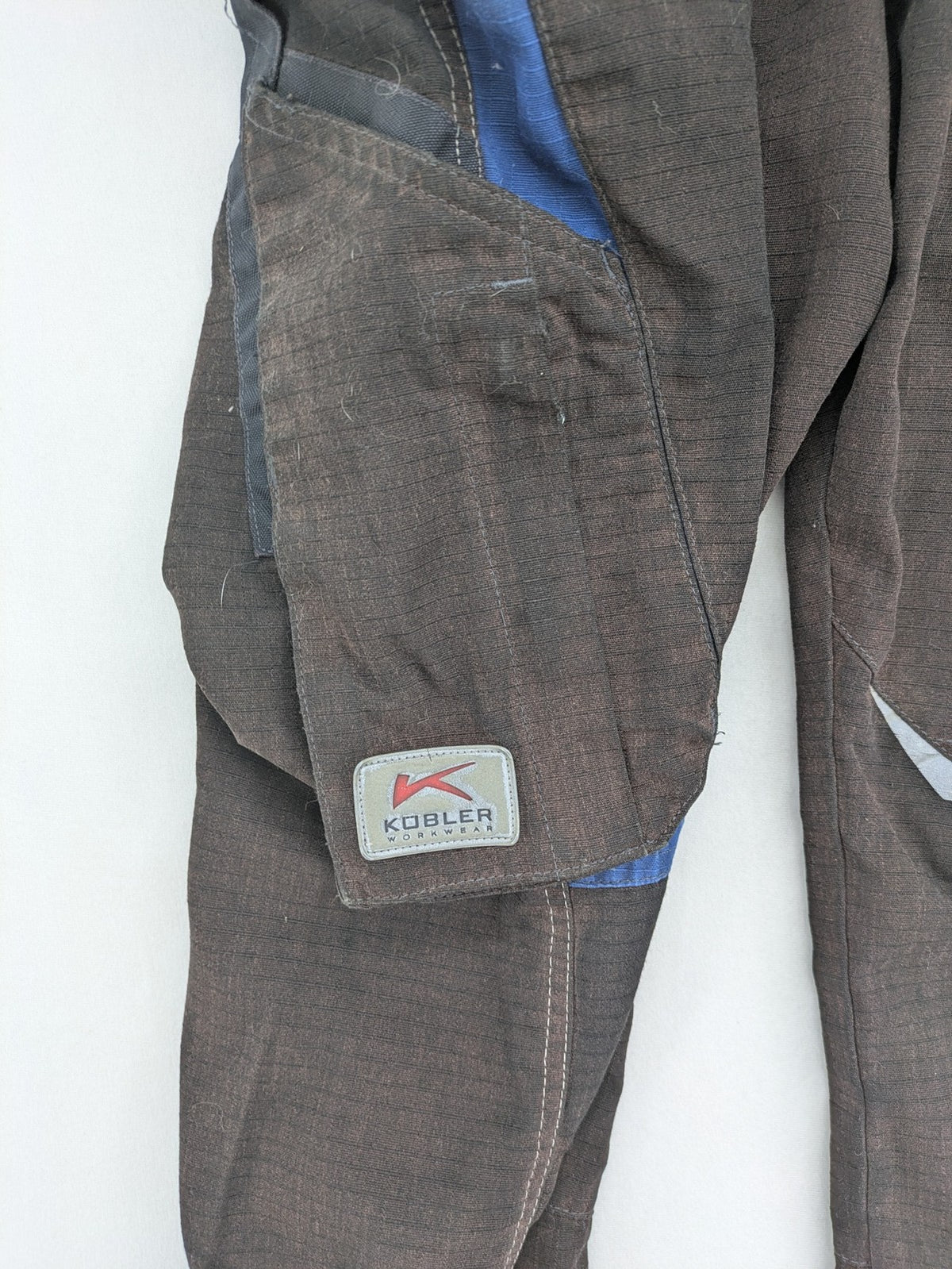 Kübler work pants blue grey Cordura fabric with multiple cargo pockets and reflective details.