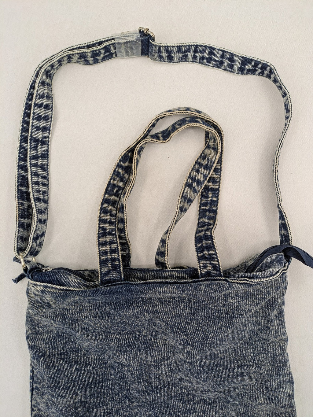 Clockhouse blue acid wash denim tote bag with adjustable shoulder strap and classic handles.