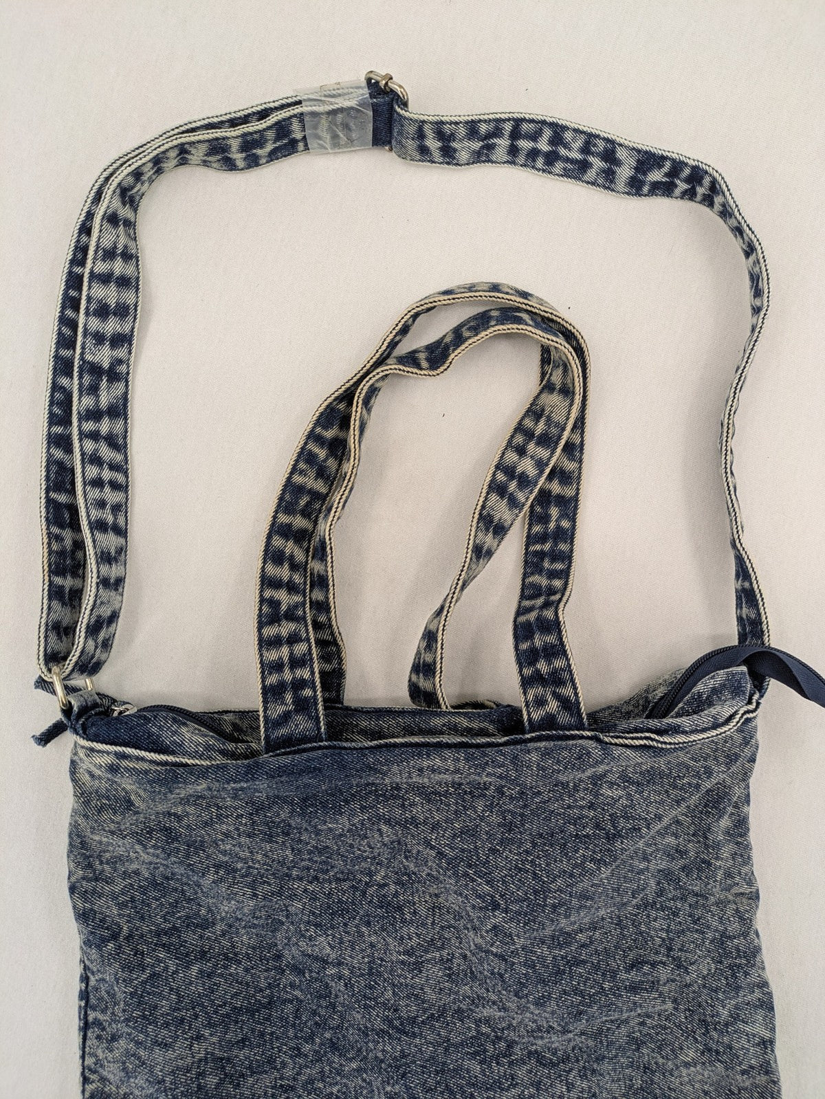 Clockhouse blue acid wash denim tote bag with adjustable shoulder strap and classic handles.