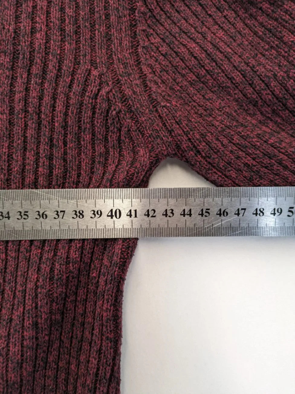Infinity burgundy turtle neck jumper with quarter-zip and ribbed knit texture.
