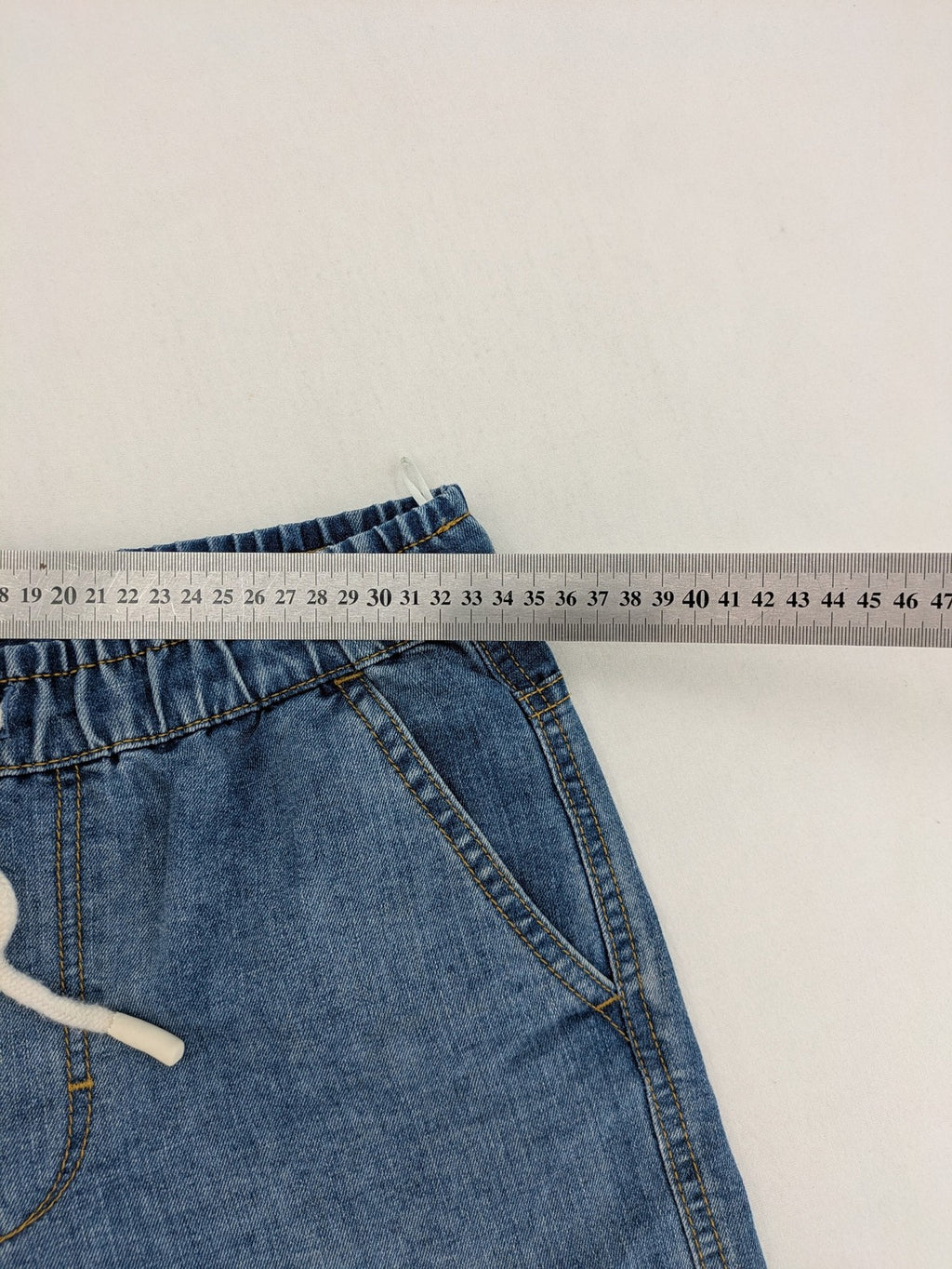 C&A blue denim shorts with elastic waistband and decorative drawstring, classic style.