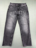 Black Squad black straight jeans with Gothic "Paranoid" lettering and faded finish.