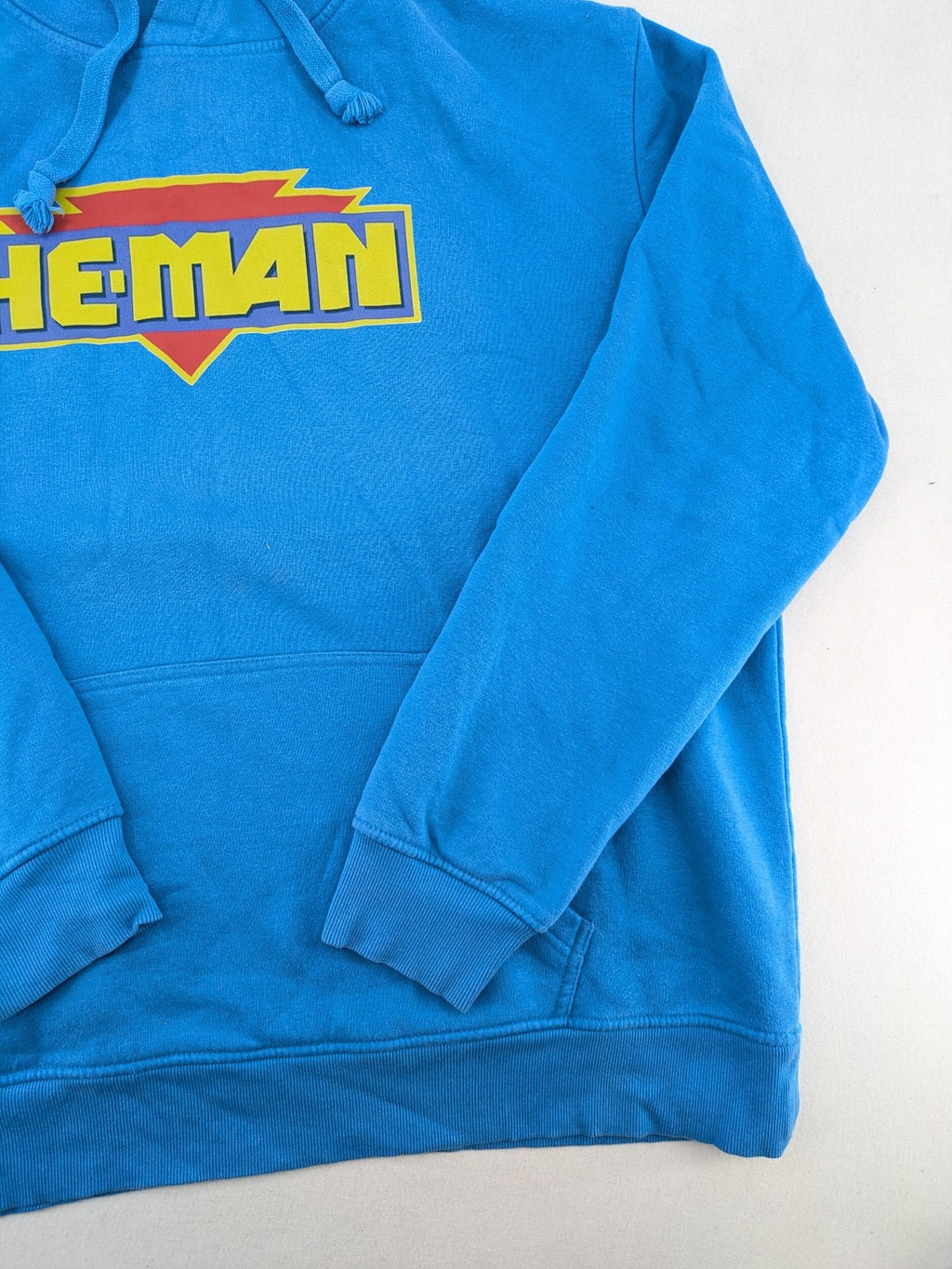 Masters of the Universe blue zip-through hoodie featuring large He-Man logo and drawstring hood.