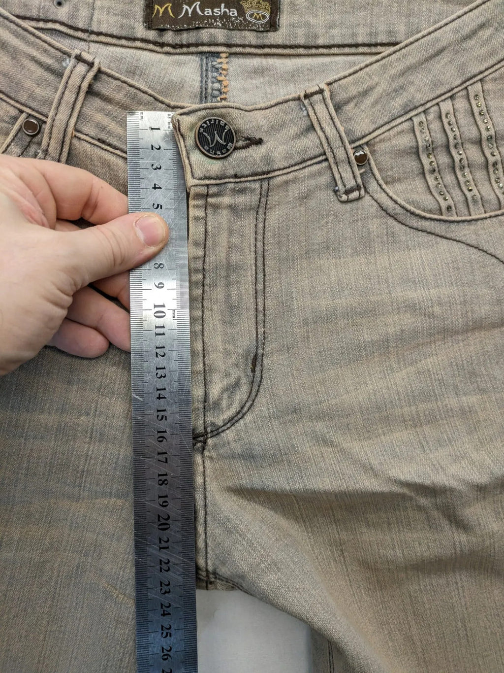 Masha khaki straight jeans with rhinestone embellishments and decorative stitching.