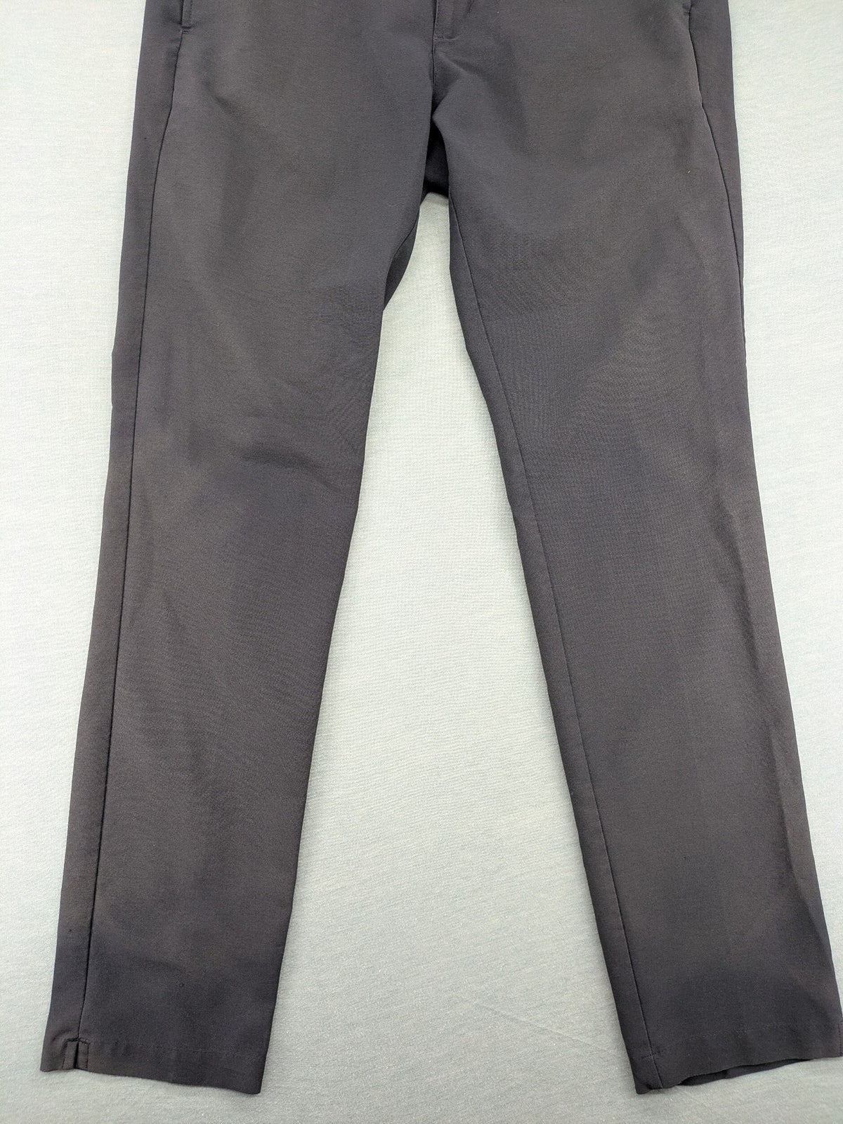 Adidas grey pants with 3-stripe logo, flat-front design, made from performance material.