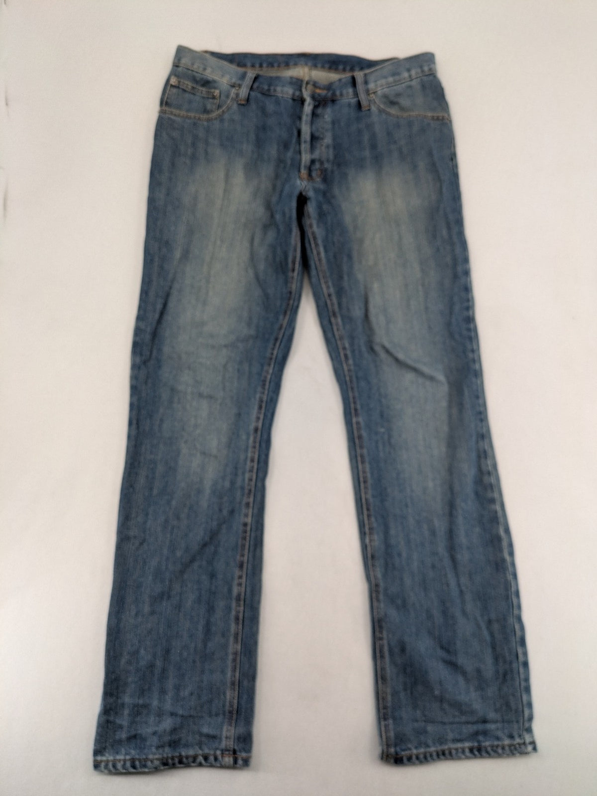 Cheap Monday blue straight jeans with button fly and classic medium wash finish.