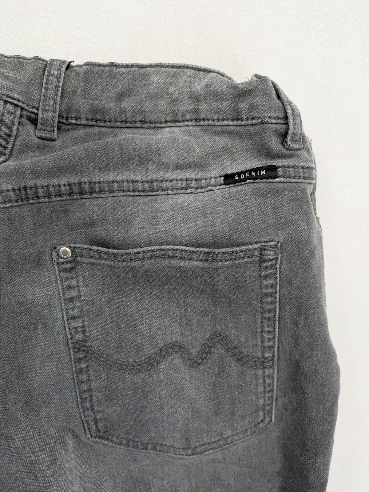 H&M grey jogger jeans with elastic waistband and drawstring, stylish washed look.