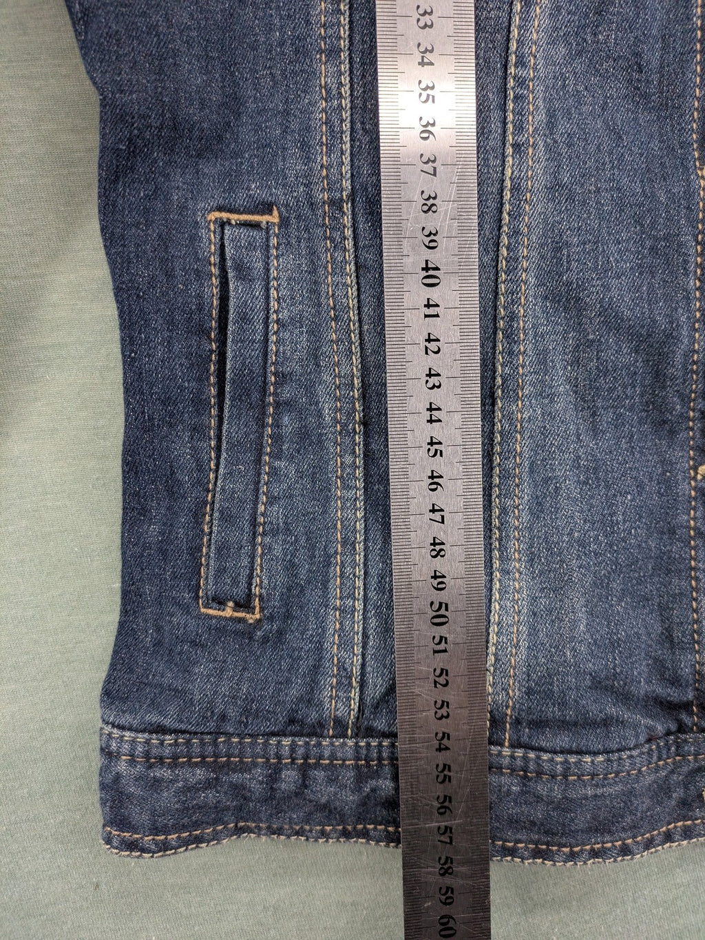 BLU blue denim trucker jacket with button placket and two chest pockets.