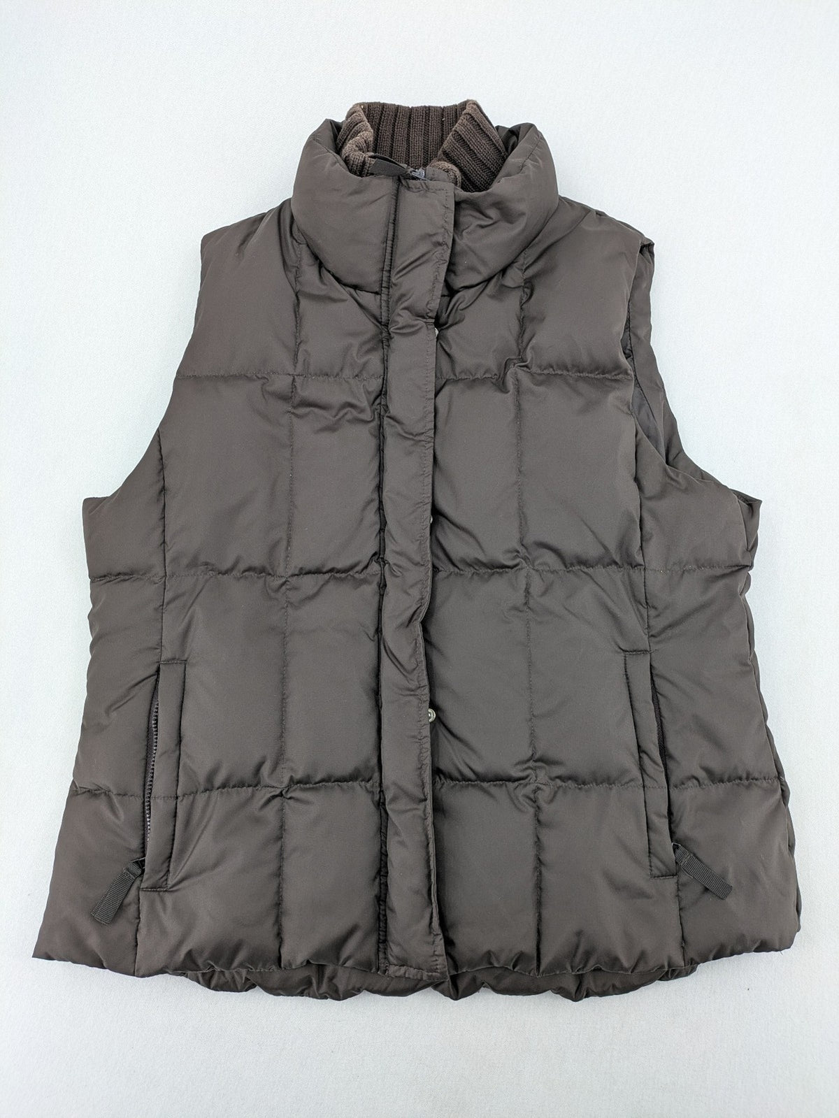 Esprit brown puffer vest with high ribbed collar and zip button closure.