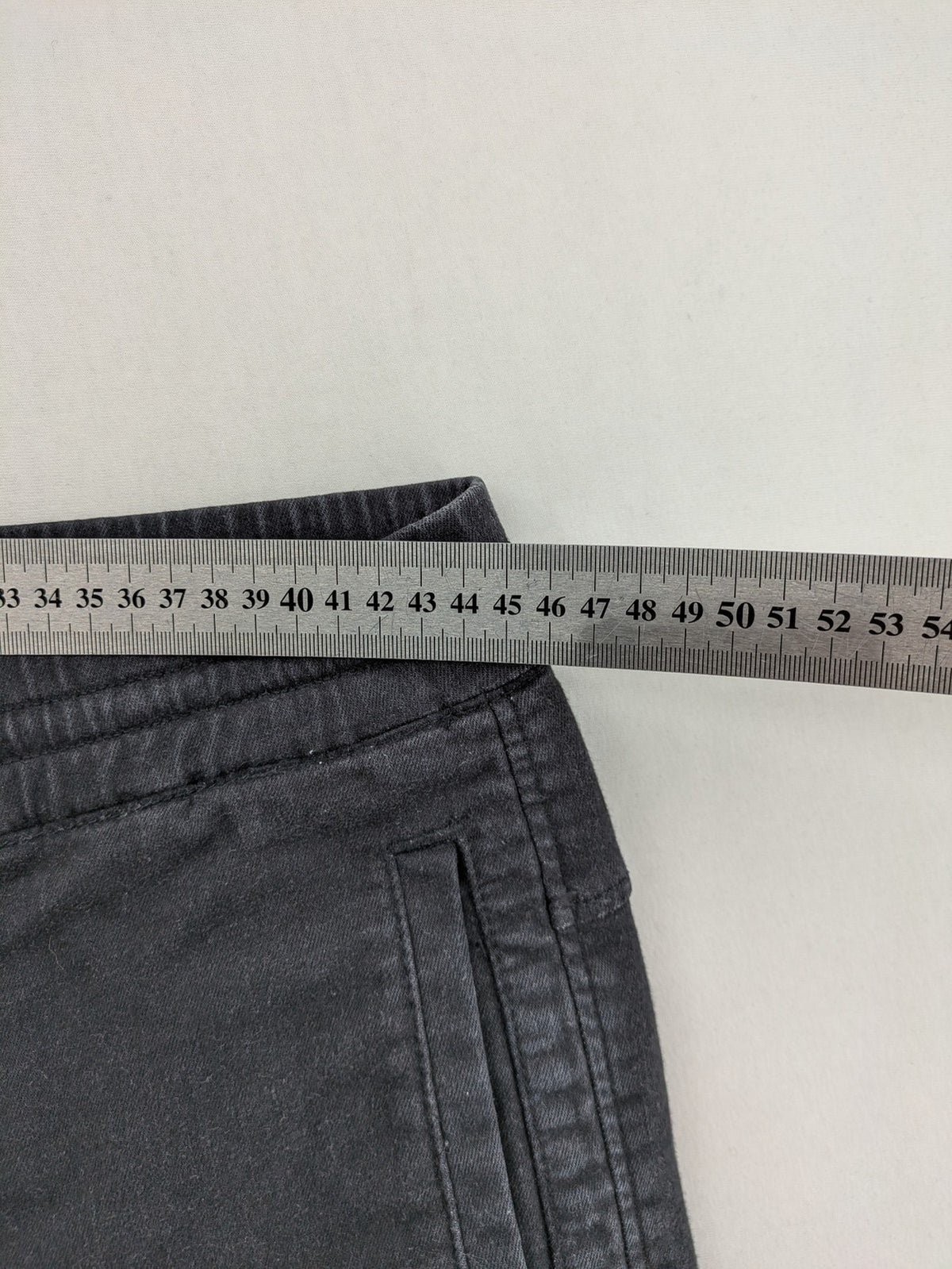 C&A grey jogger pants with elastic cuffs, drawstring waist, and multiple pockets.