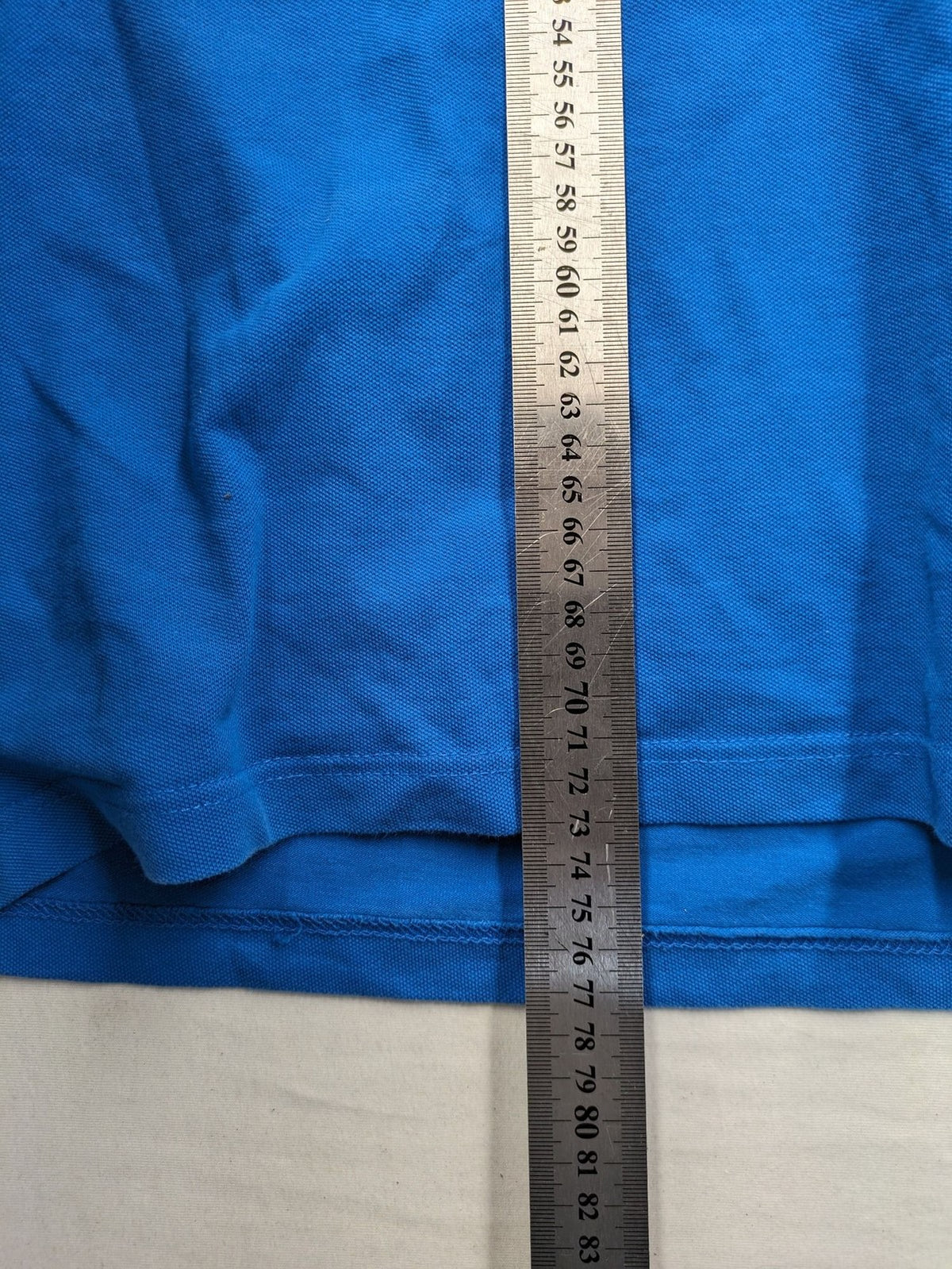 Tommy Hilfiger blue polo shirt with white stripes and embroidered logo on chest.