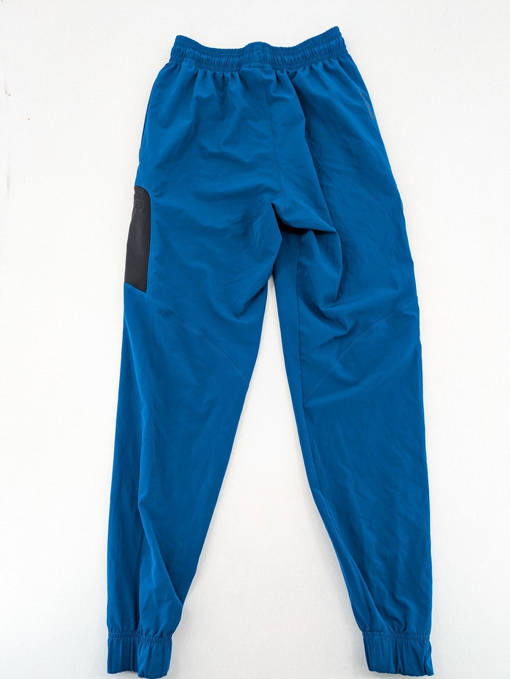 Under Armour blue HeatGear joggers with black accents and zippered cargo pockets.
