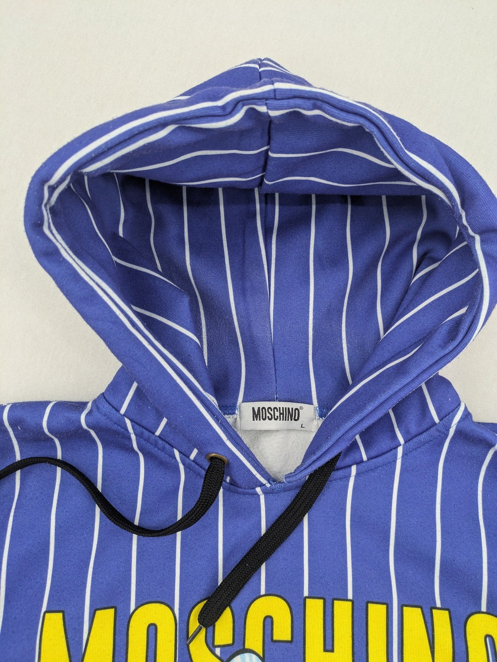 Moschino multi turtle neck jumper blue and white striped with Tasmanian Devil graphic.