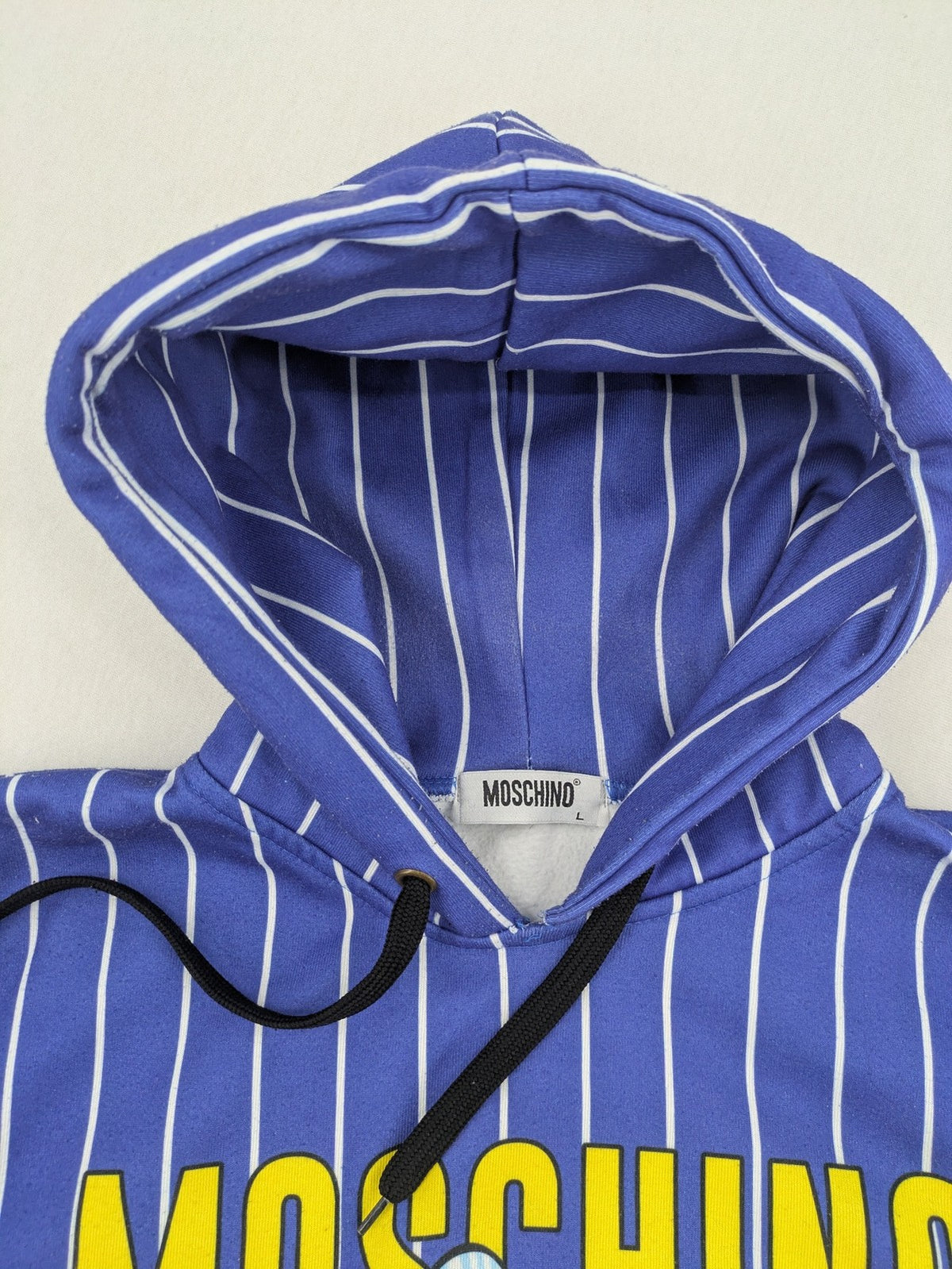 Moschino multi turtle neck jumper blue and white striped with Tasmanian Devil graphic.
