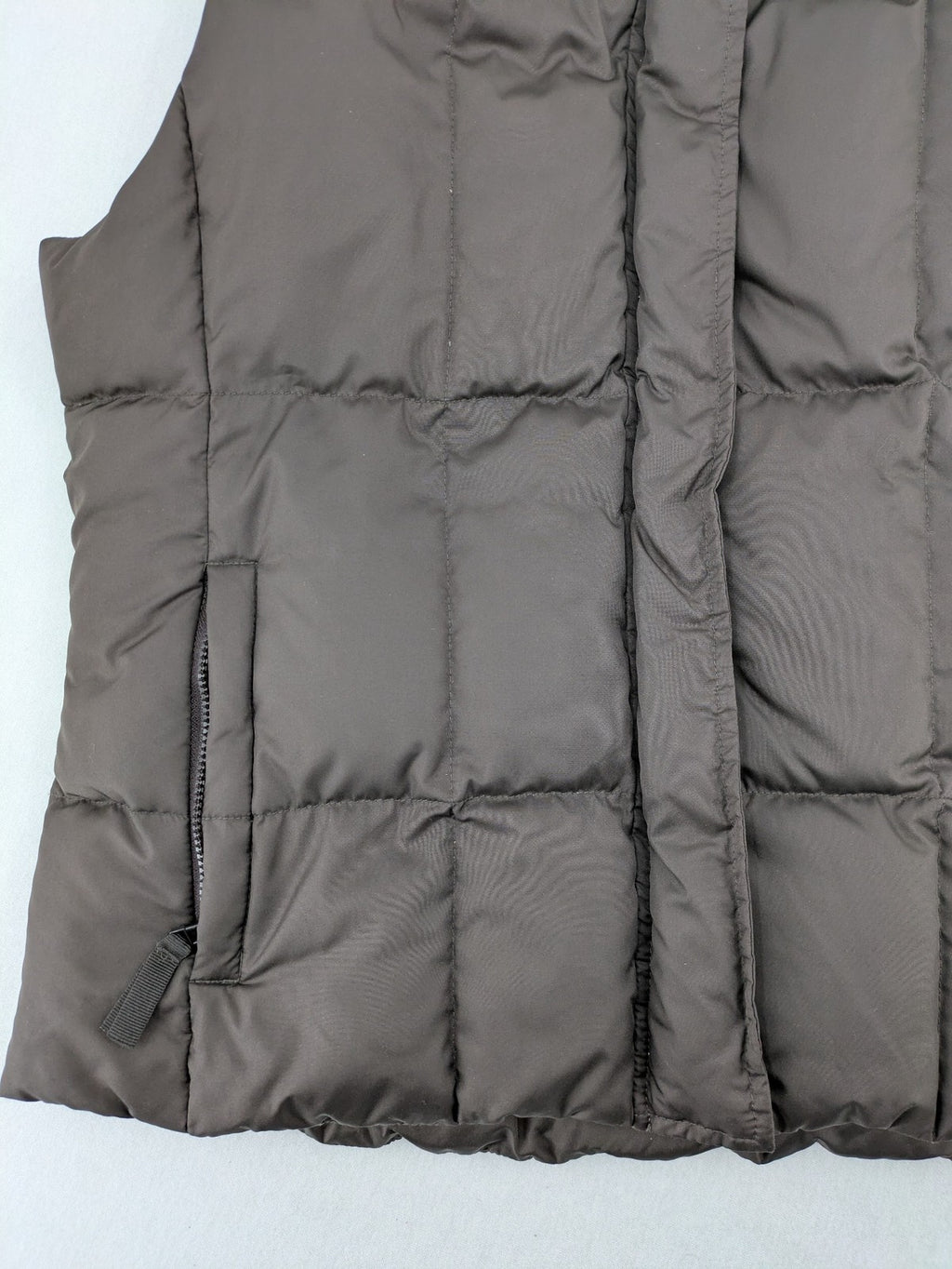 Esprit brown puffer vest with high ribbed collar and zip button closure.