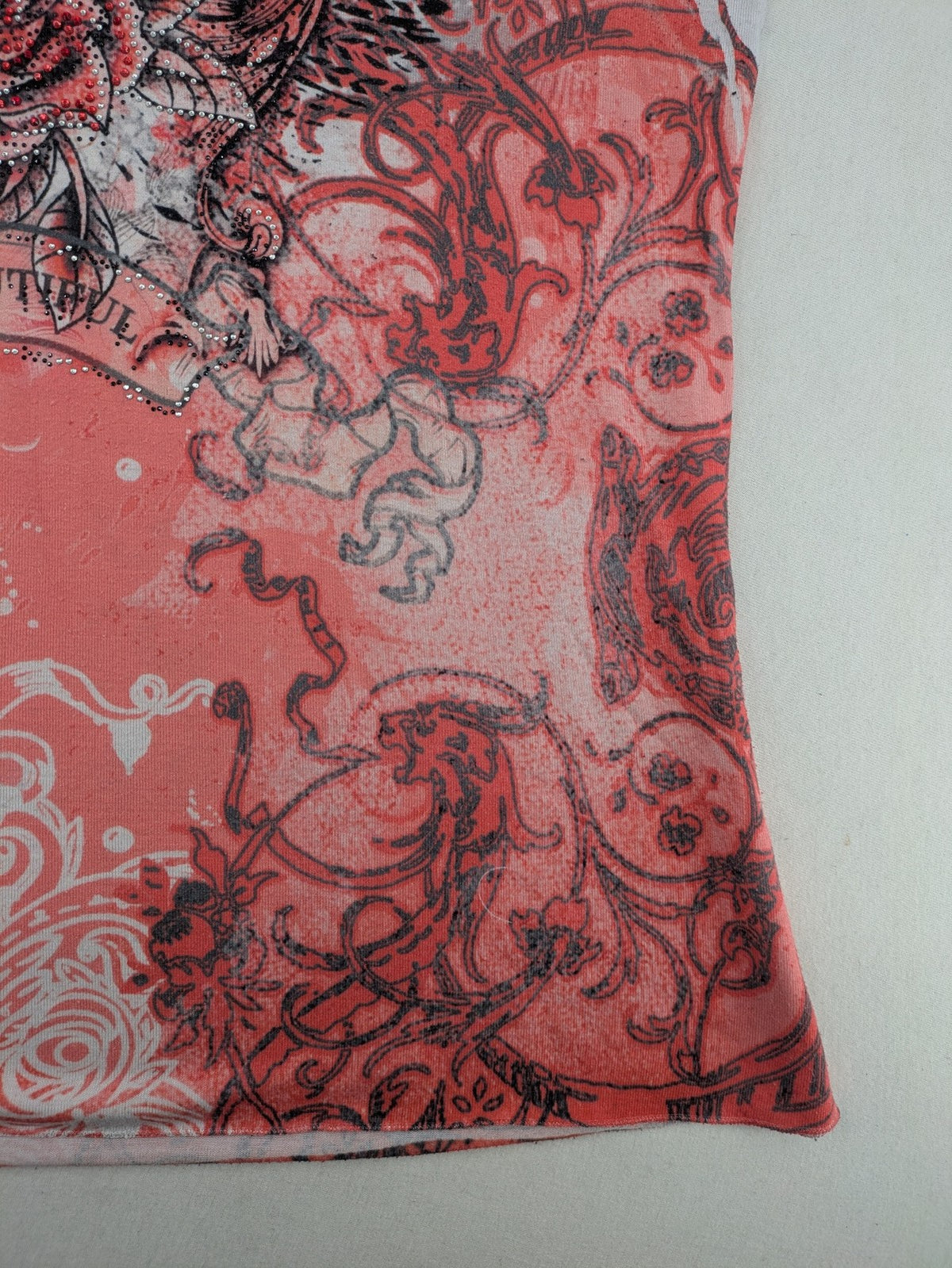 TREDY pink graphic top with rose and wings design, embellished with rhinestones.