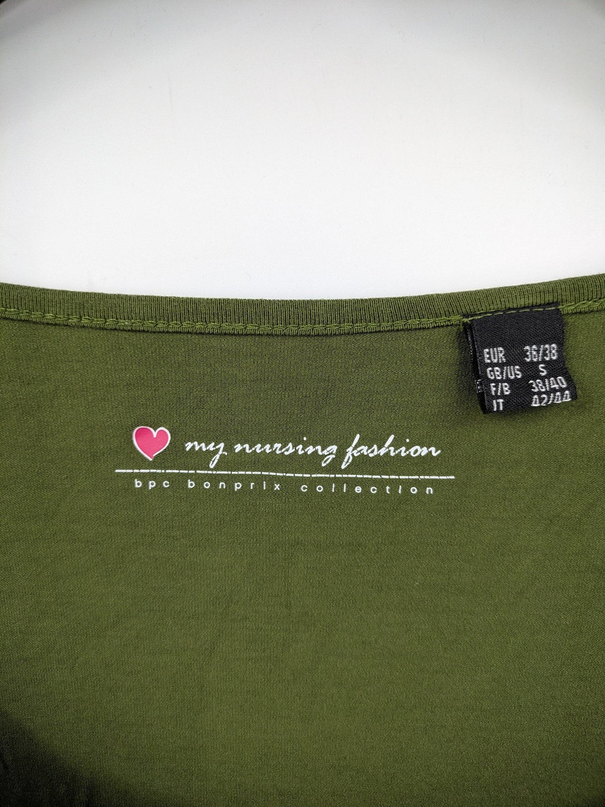 Bonprix green maternity dress with layered V-neck and empire waist design.
