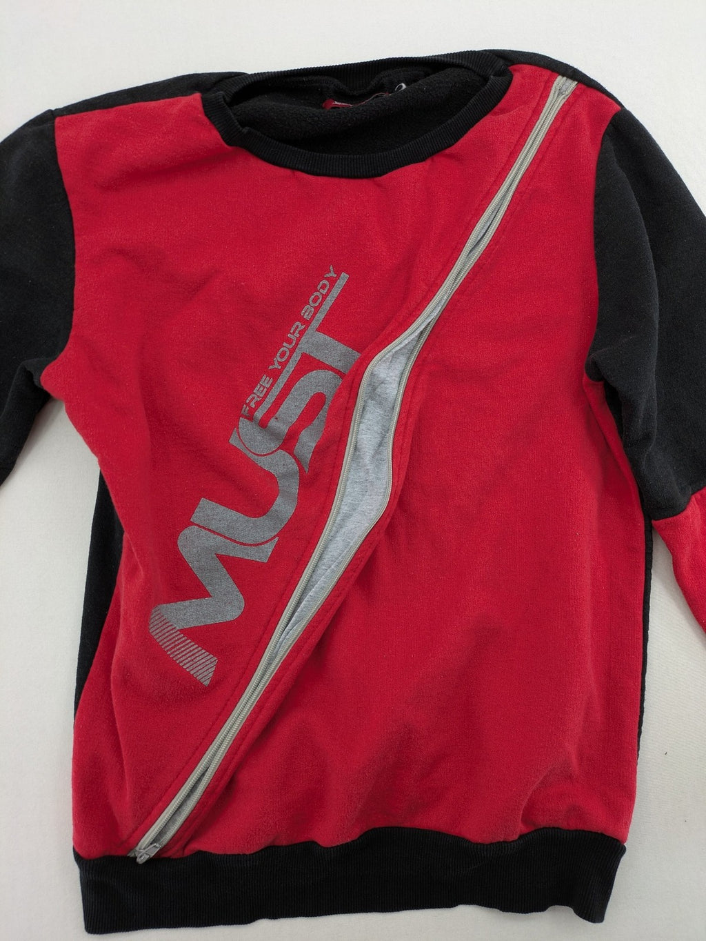 Boystar vintage turtle neck jumper red black colorblock with "MUST FREE YOUR BODY" graphic.