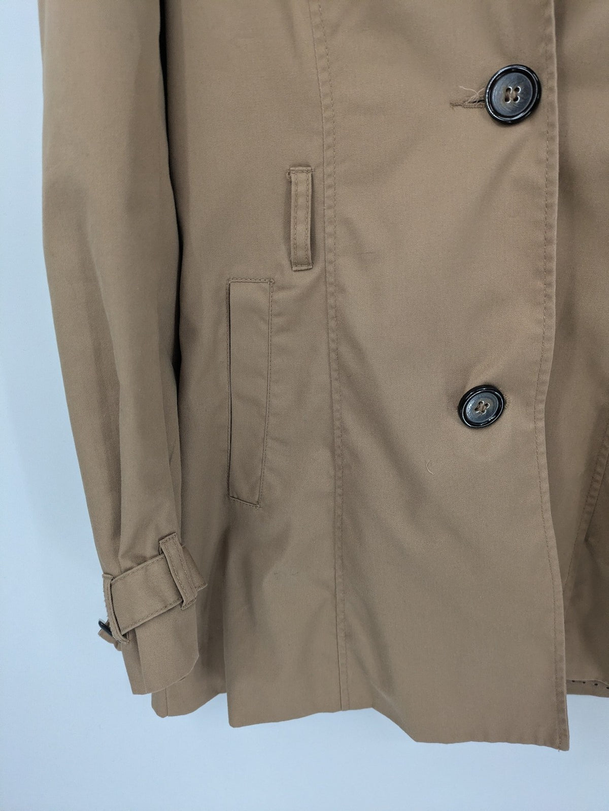 H&M Divided beige trench coat with button closure, hood, and polka dot lining.