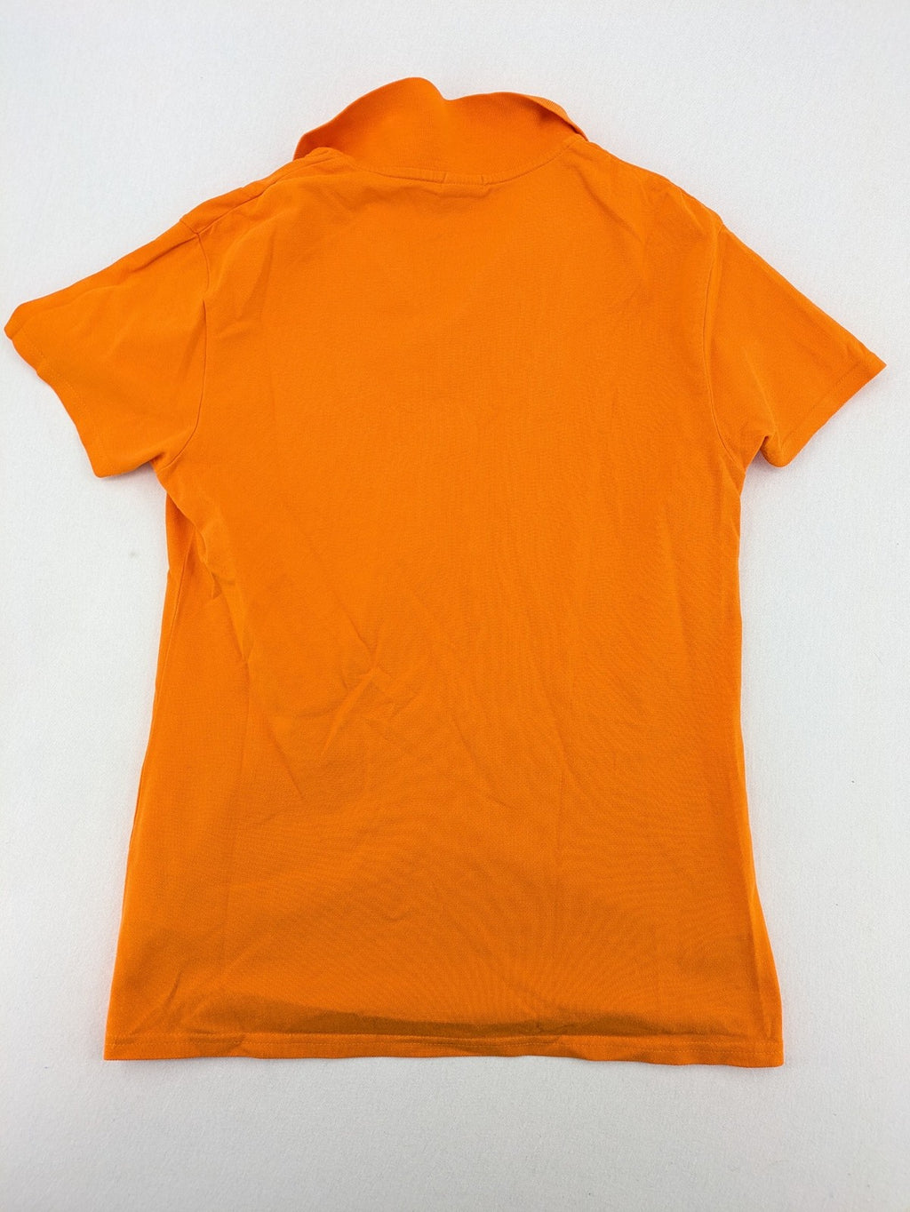 Teejays orange polo shirt with embroidered logo, classic collar, and button placket.