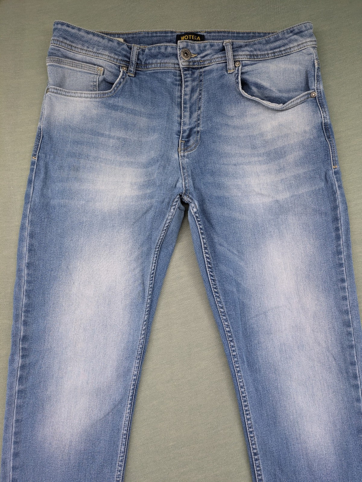 Wotega blue straight jeans light wash faded with classic 5-pocket design and stretch material.