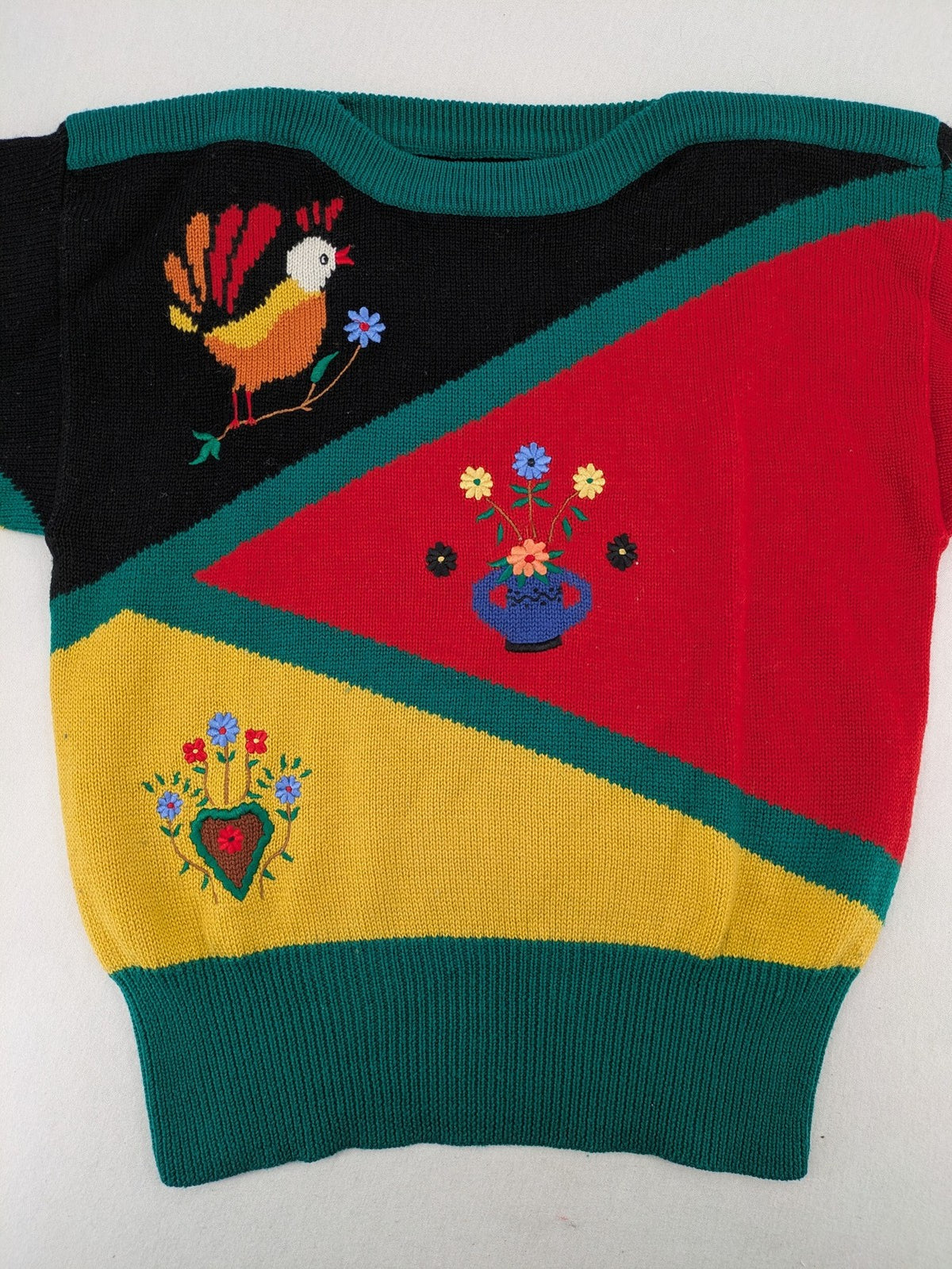 Pullover multi knit jumper featuring colorful block pattern and embroidered rooster and flowers.