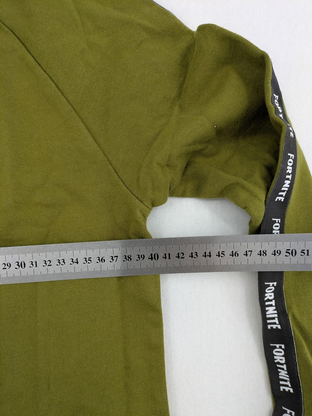 Fortnite green camo hoodie with black logo, contrasting hood, and logo taping on sleeves.