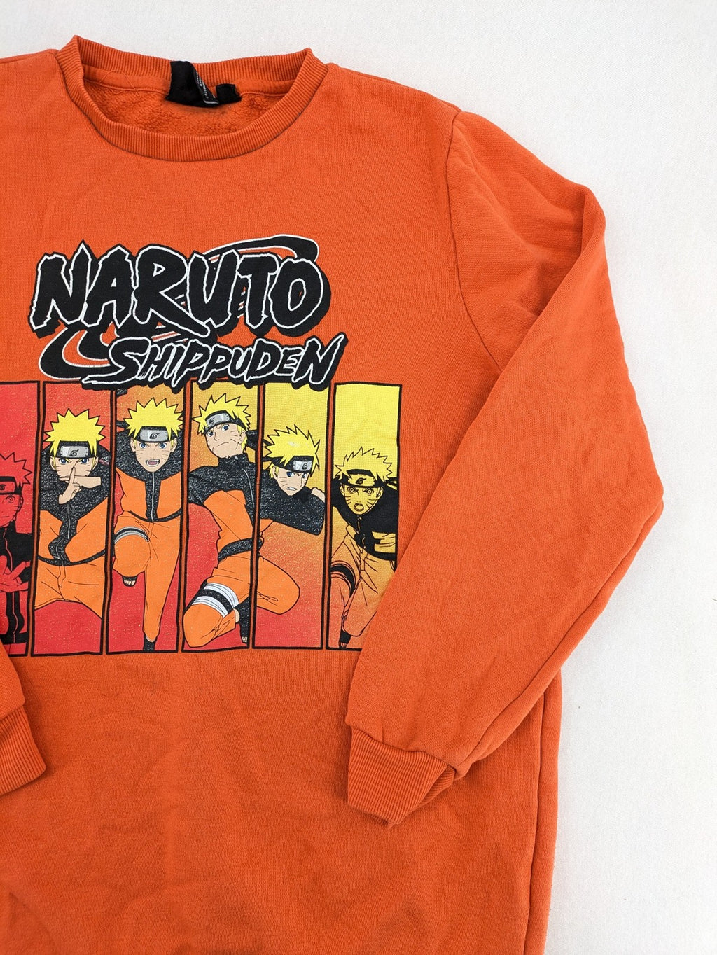 Naruto Shippuden orange sweatshirt featuring vibrant Naruto Uzumaki graphic print, classic crew neck.