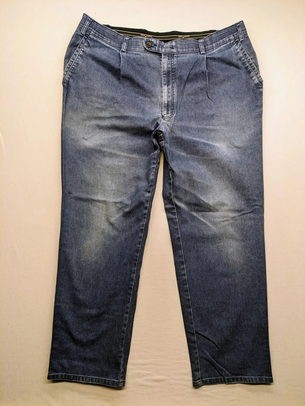 REI blue straight jeans with front pleats, zip fly, and buttoned back pockets.