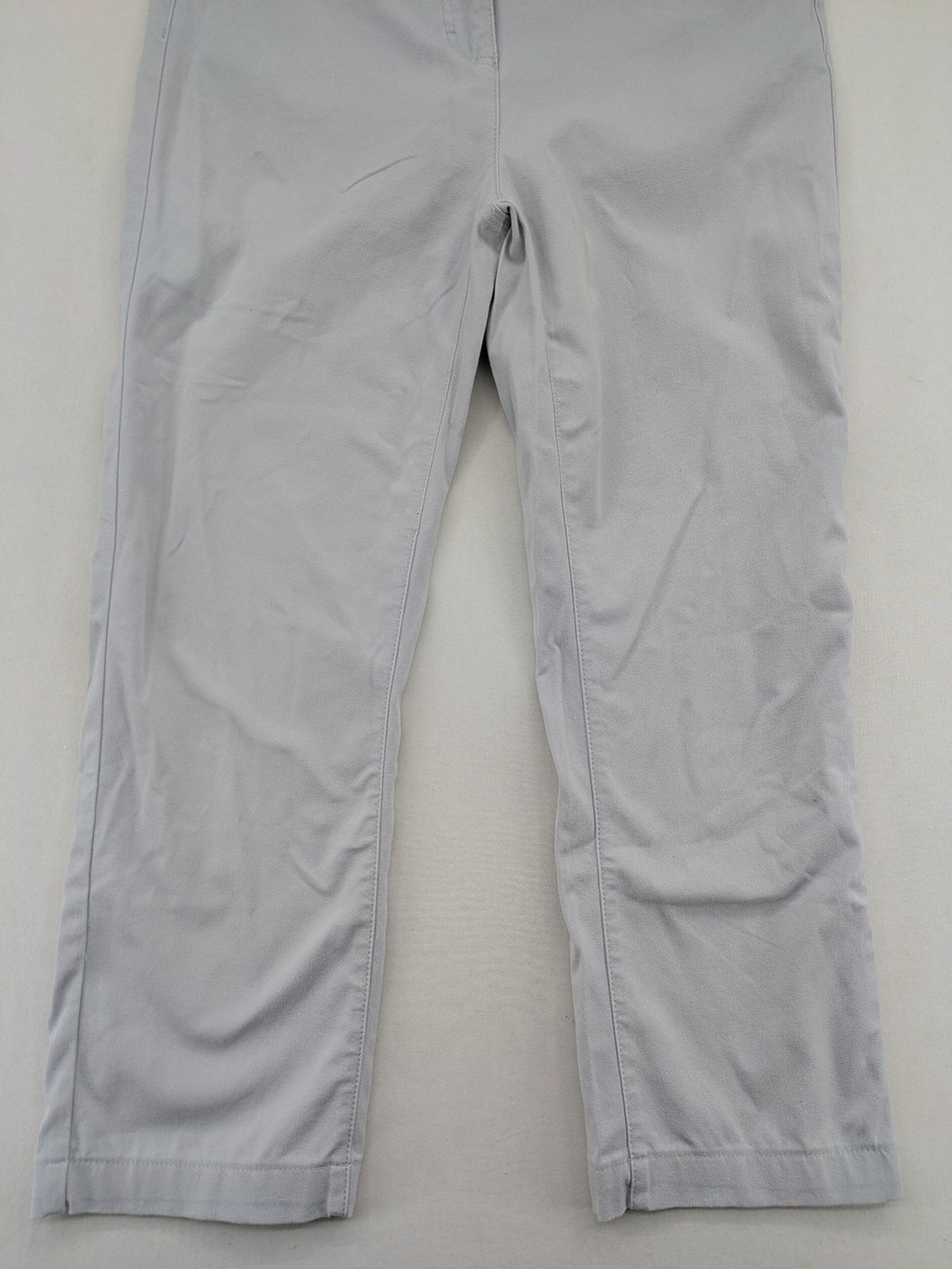 Chino grey capri pants five-pocket design with subtle embroidery and stretch cotton blend.