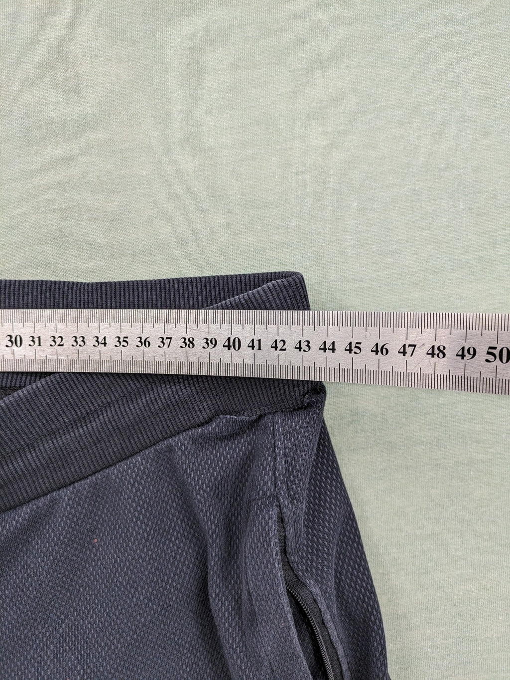 Nike F.C. grey jogger pants with elastic waistband, side pockets, and embroidered Swoosh logo.