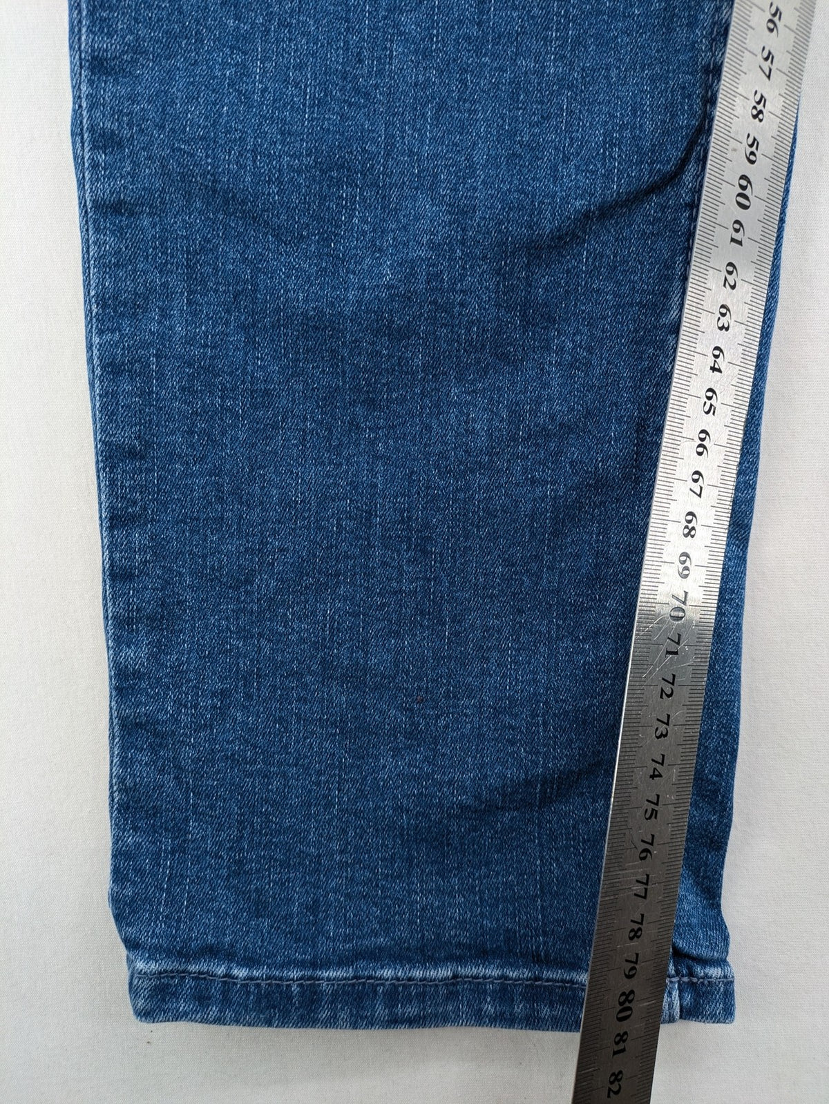 7 For All Mankind blue straight jeans with 5-pocket design and logo on back pocket.