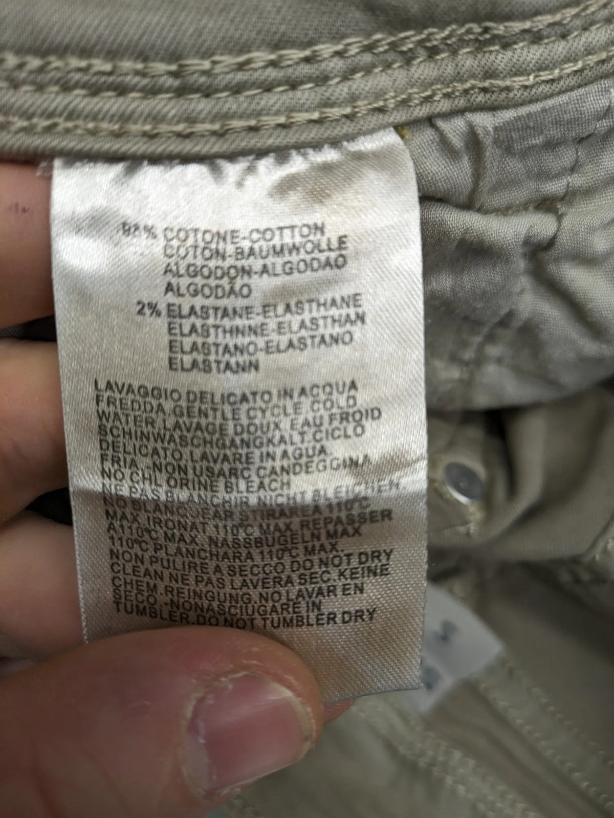 Mozaar beige straight jeans with unique asymmetrical button placket and practical pockets.