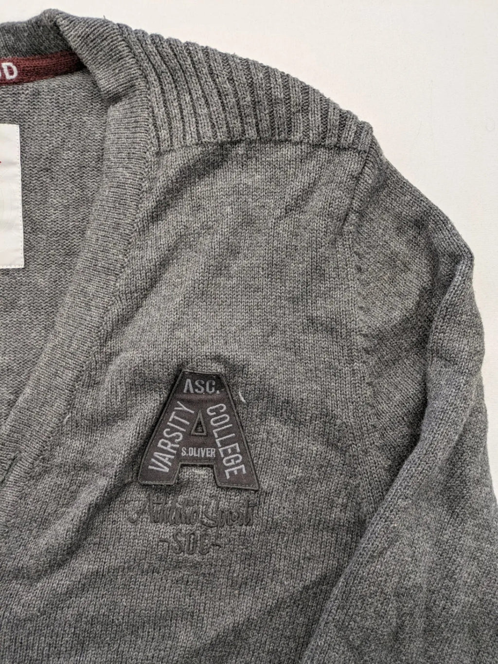 s.Oliver grey turtle neck jumper with varsity college patch and button closure.
