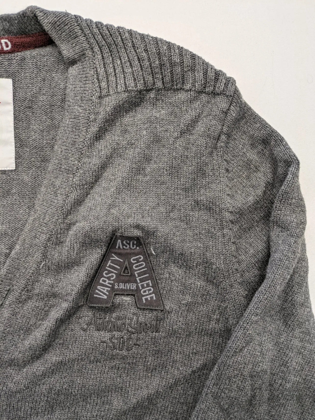 s.Oliver grey turtle neck jumper with varsity college patch and button closure.
