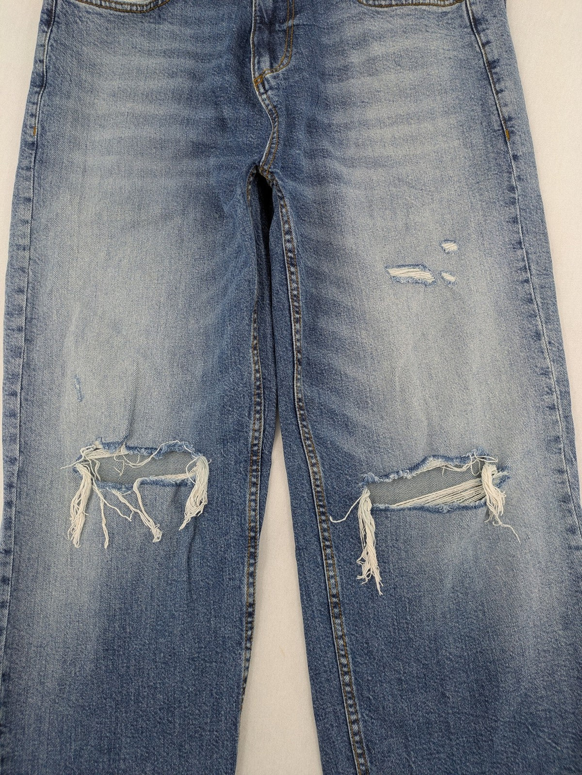 FSBN blue straight jeans with ripped distressed knees and classic button fly.