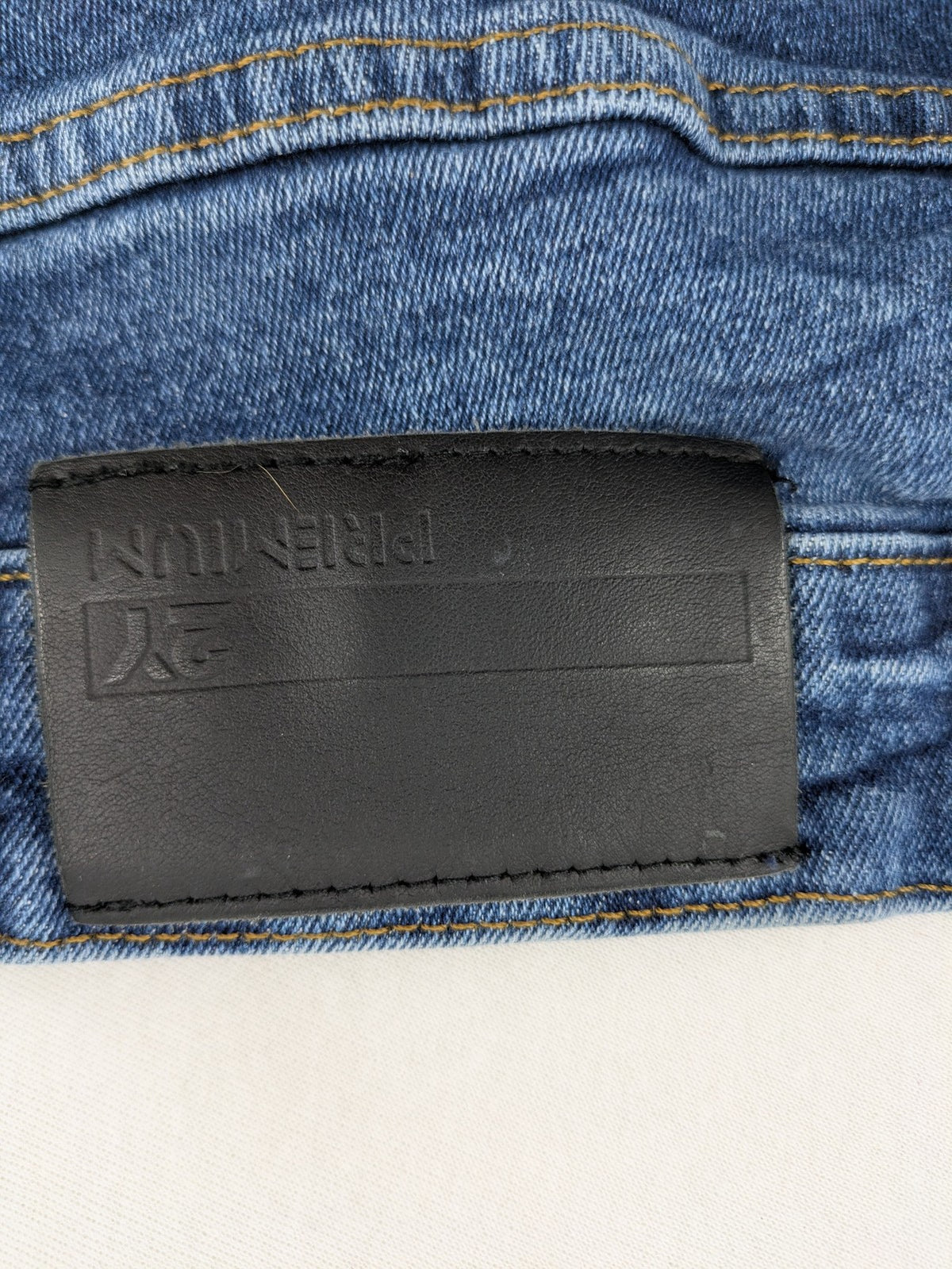 2Y Premium blue skinny jeans with distressed details and classic button fly.