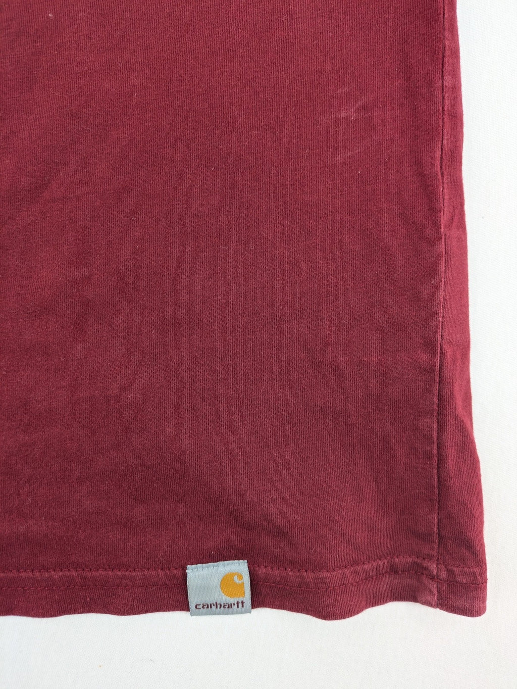Carhartt burgundy tank top 100% cotton with iconic logo patch at hem.