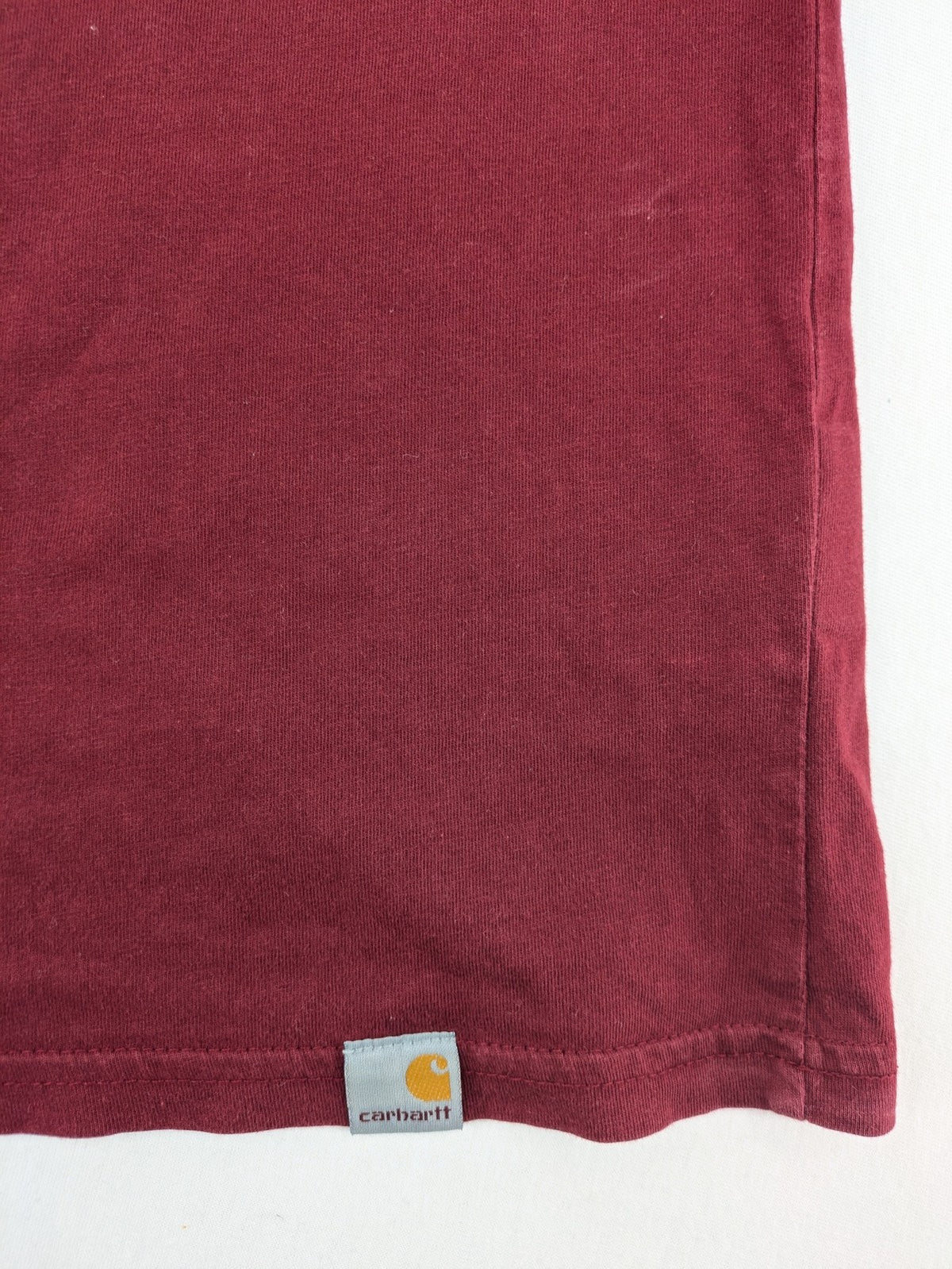 Carhartt burgundy tank top 100% cotton with iconic logo patch at hem.