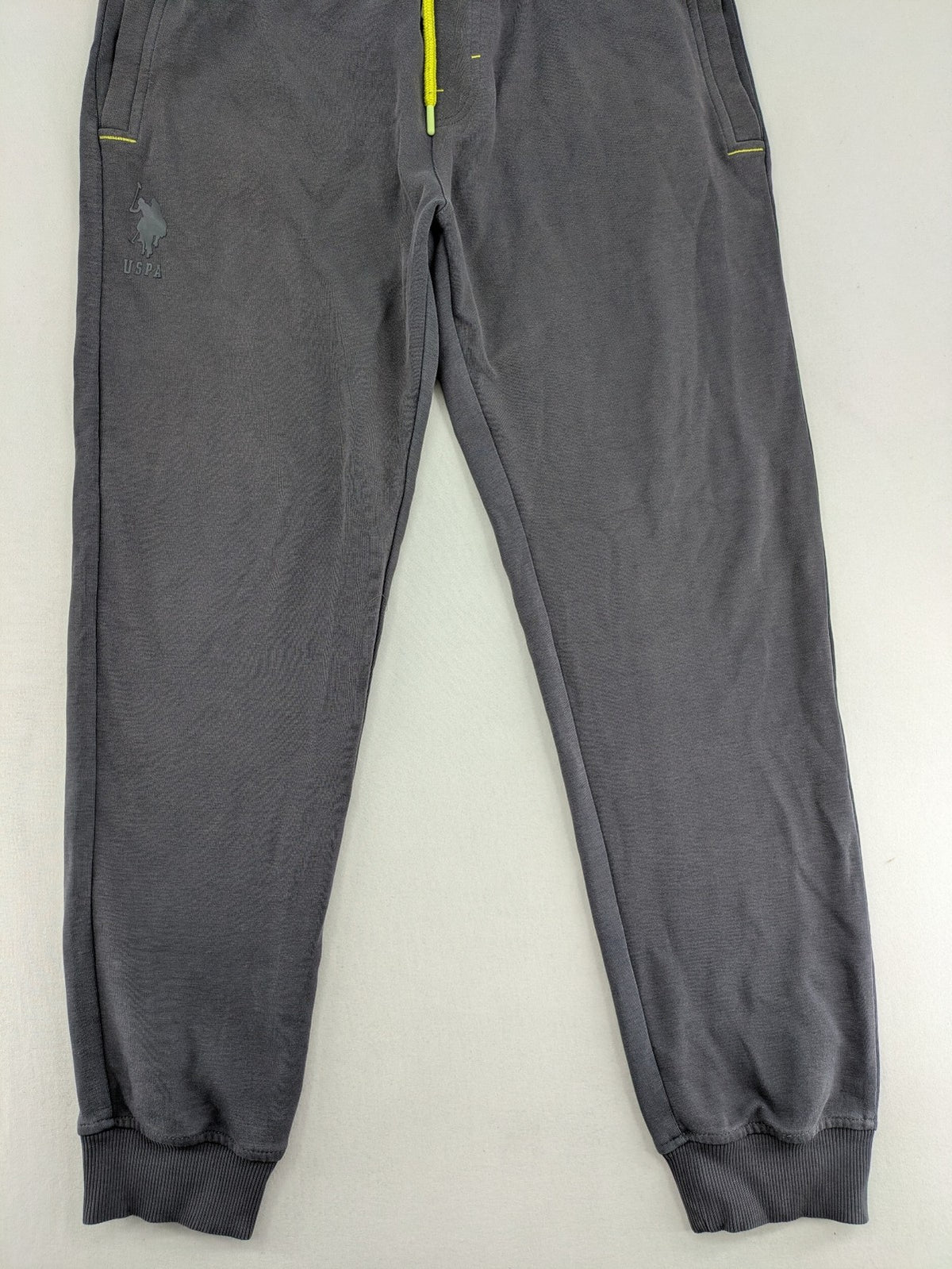 US Polo Assn grey sweatpants with light green drawstring and subtle logo detail.