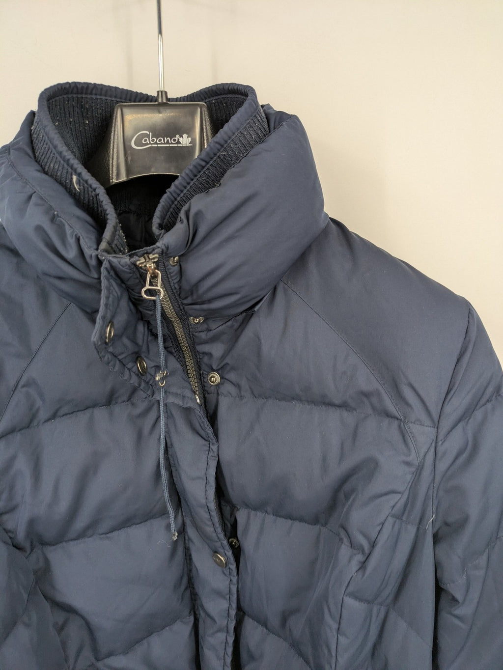 Esprit navy puffer jacket with belt, high collar, ribbed inner lining, and button placket.
