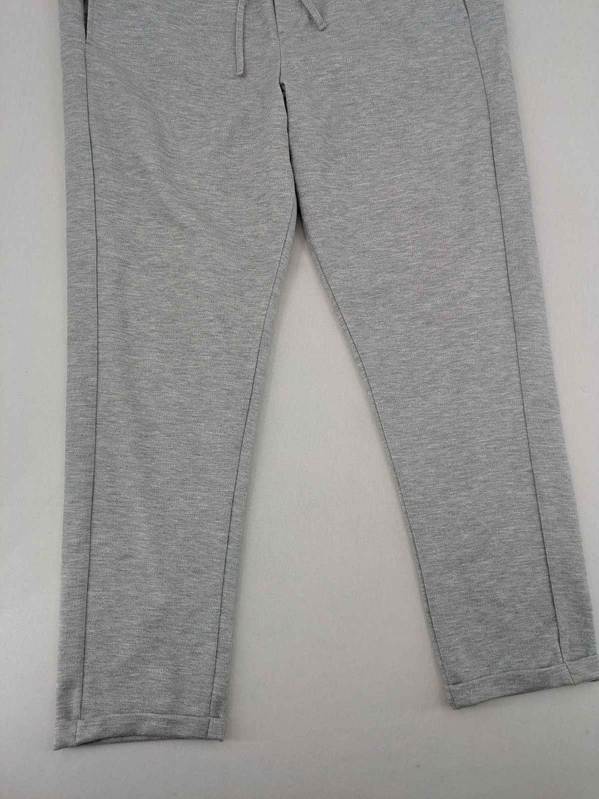 C&A grey sweatpants with elastic waistband, adjustable drawstring, and side pockets.