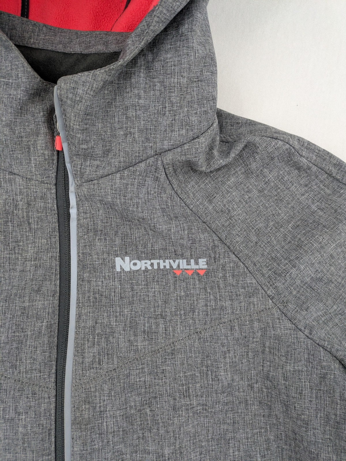 Northville grey and red softshell jacket with hood, fleece lining, and reflective elements.