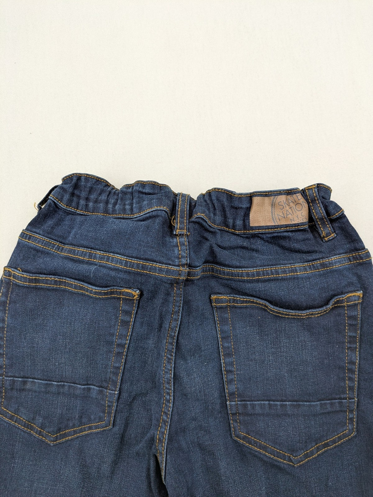 Skate Nation blue straight jeans 5-pocket design with adjustable waistband and dark wash.